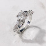 Round CZ Solitaire Curved Pavé Band Ring