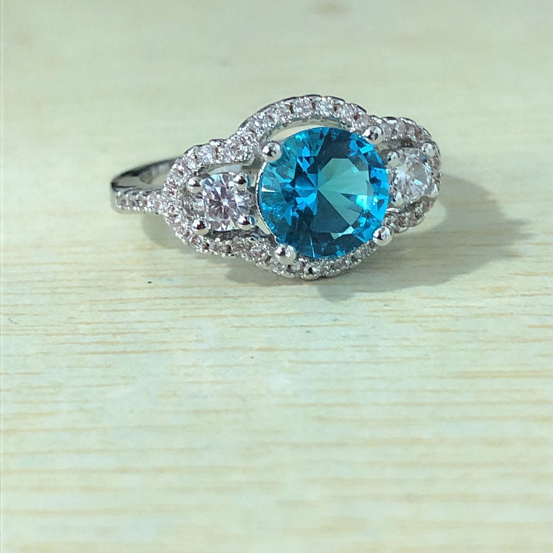 Aqua-Blue Round CZ Three-Stone Halo Ring