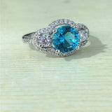 Aqua-Blue Round CZ Three-Stone Halo Ring