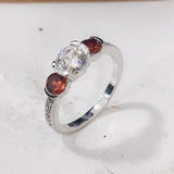 Garnet-Red and Clear CZ Three-Stone Ring